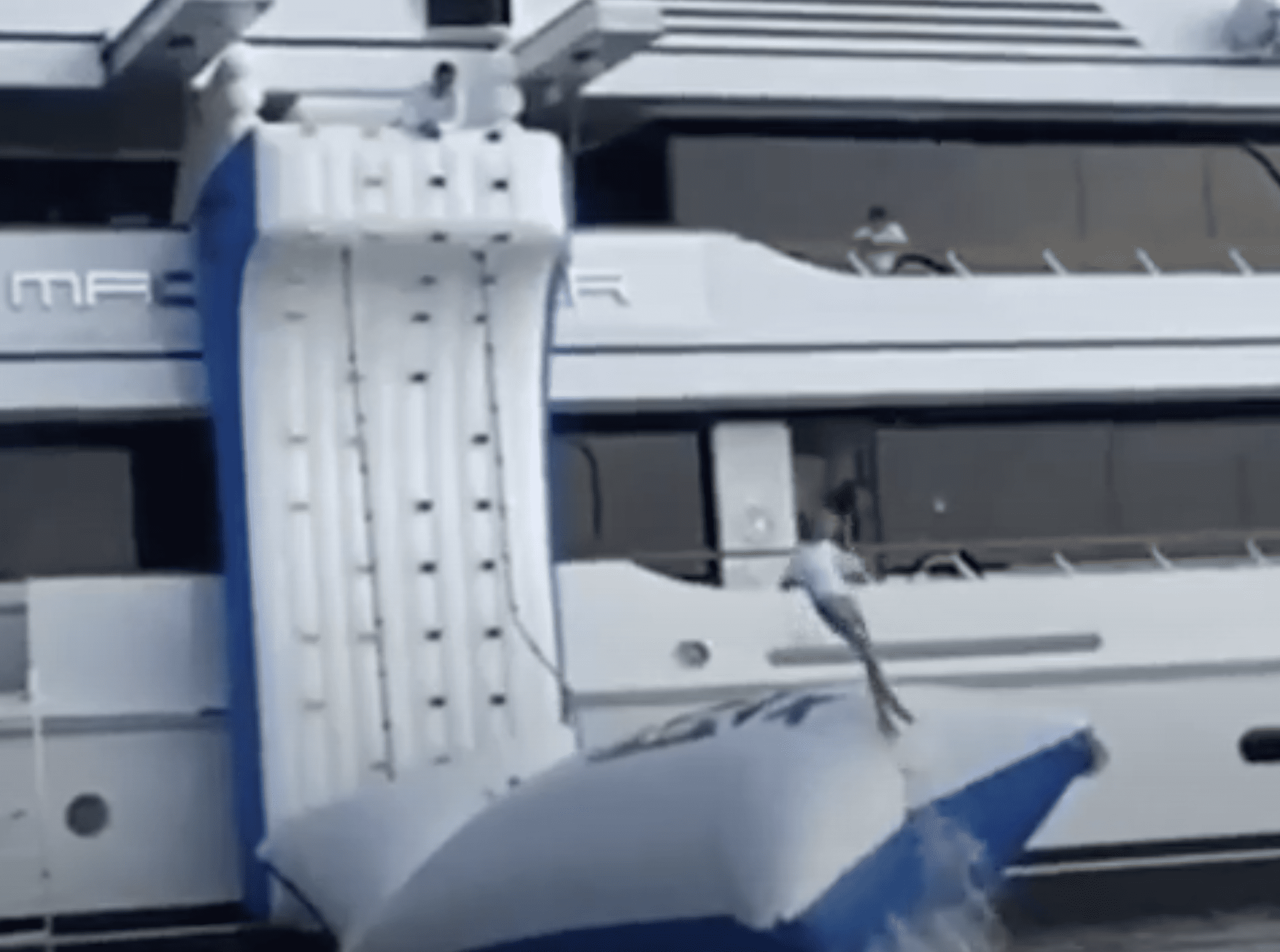 FunAir Climbing Wall and Blob combo with lady jumping higher than the top deck of the yacht