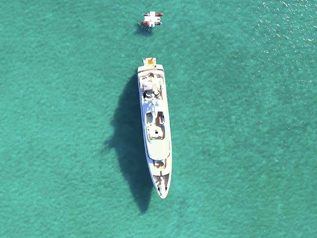 Drone view of Motor Yacht Latitude towing her FunAir Toy Island