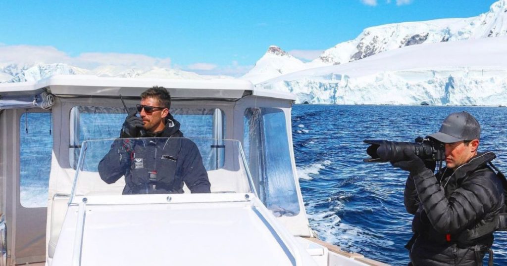 Deckhand on a yacht tender with photographer exploring Alaska