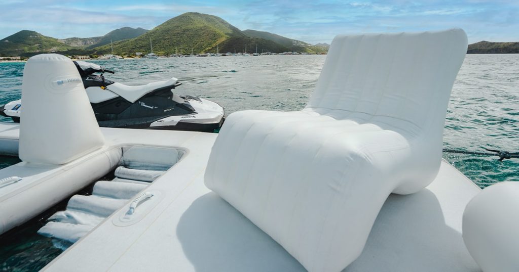 FunAir Inflatable Wave Chair on the Sea Pool of a charter superyacht with a jet ski and island in the background