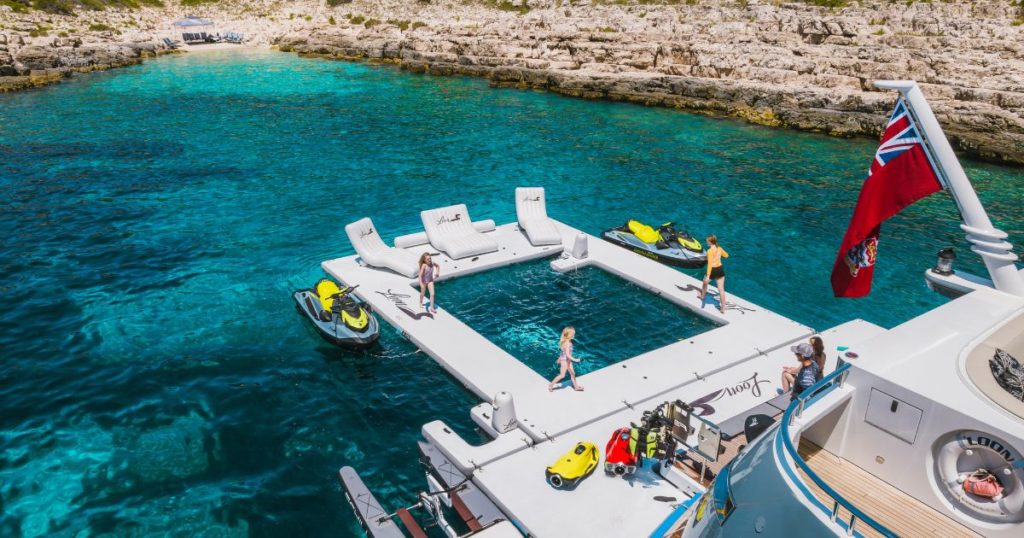 Superyacht charter guests in Croatia enjoying the wide FunAir Sea Pool edge with custom Wave Loungers to relax afterwards
