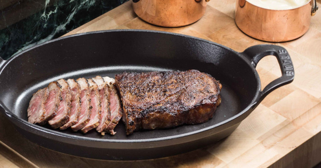 Steak in a roasting pan from a delivery service in Monaco