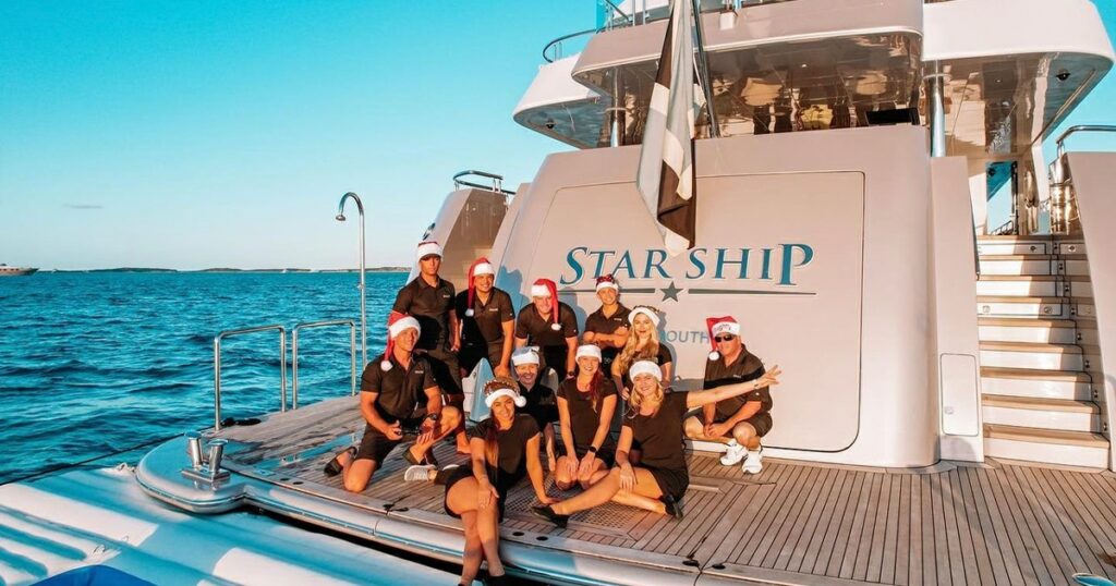 Crew of Motor Yacht Starship wearing Xmas hats