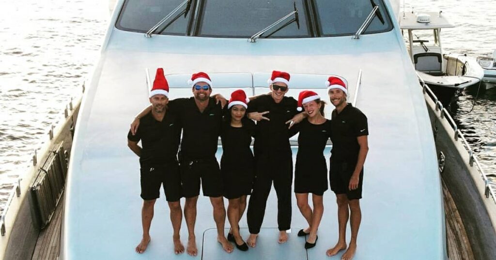 Crew of superyacht Taillights on deck with Xmas hats