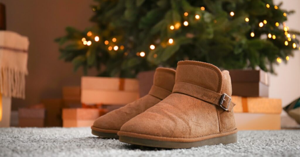 Ugg boots in front of a Christmas Tree