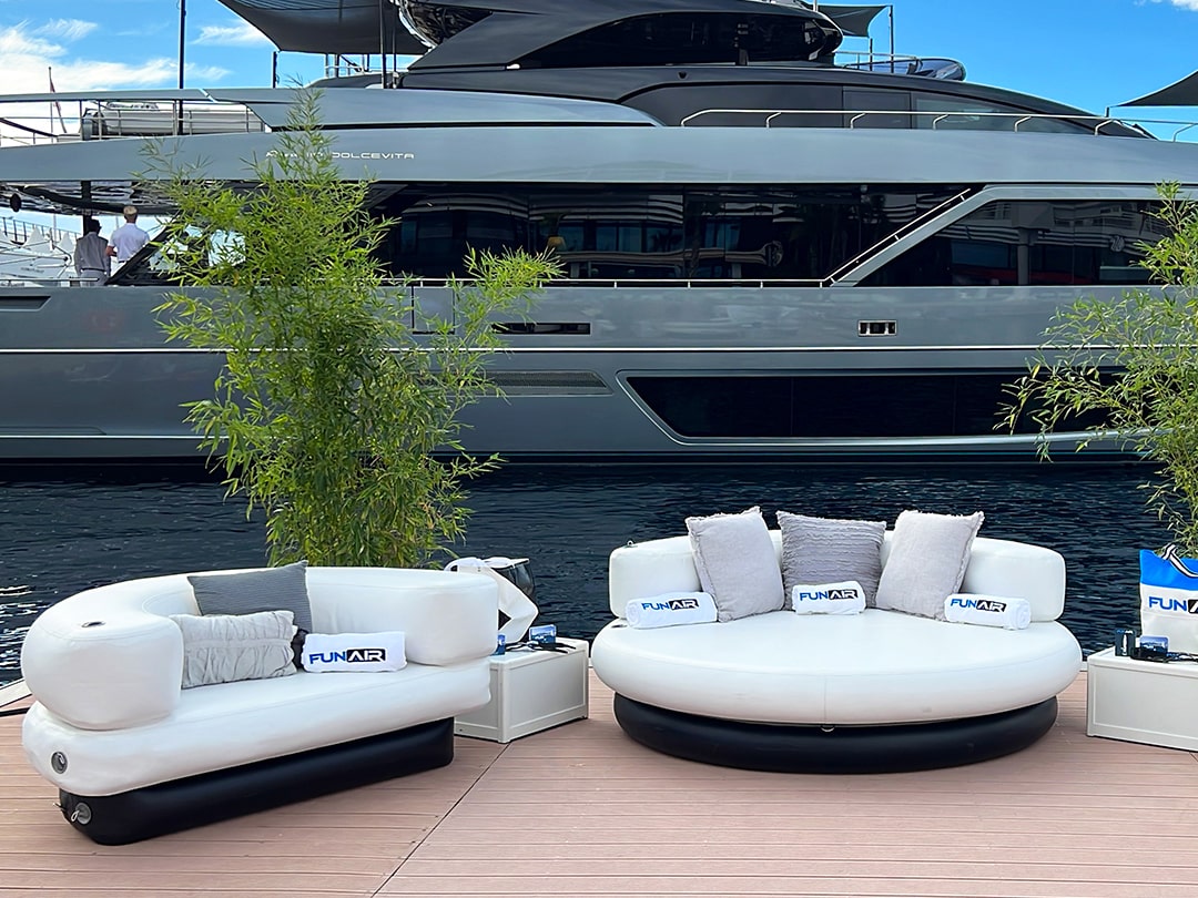 FunAir Club Chair and Club Chaise in front of a charter superyacht