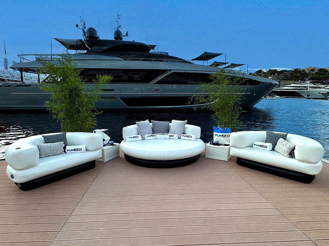FunAir superyacht inflatable Club Chaise and Club Chairs in front of a charter yacht at MYS 2022