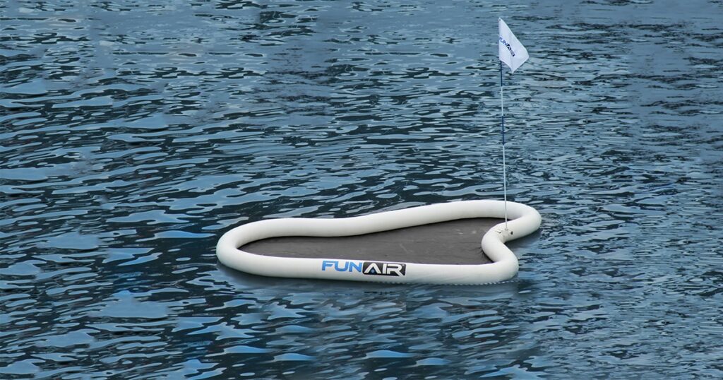 A FunAir Yacht Golf Floating Green in the water