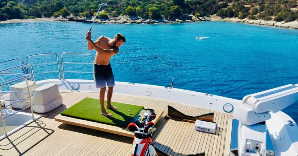 Man playing FunAir Yacht Golf on the deck of charter yacht MY Emotion 2