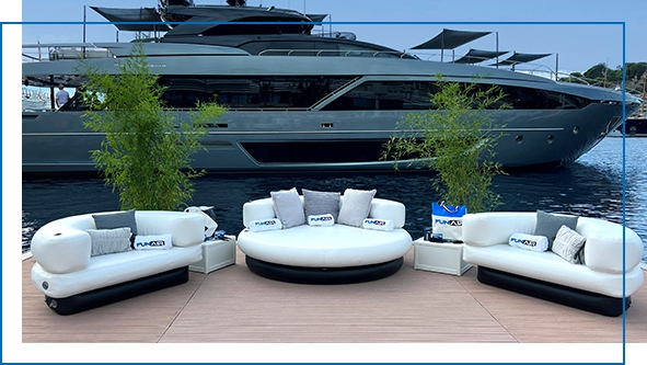 Club Chaise and Club Chairs in front of a charter superyacht