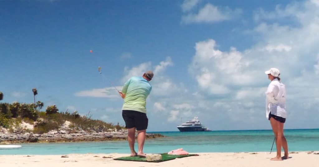 Couple playing FunAir Yacht Golf on a Caribbean beach