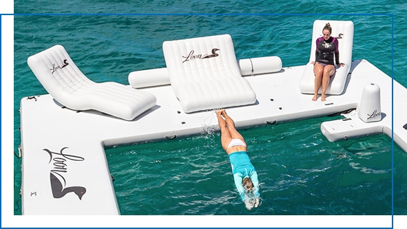 Yacht charter guest relaxing on a customer superyacht wave lounger on the beach club sea pool of Motor Yacht Loon