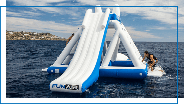 A charter guest on the water mat of a floating inflatable playground