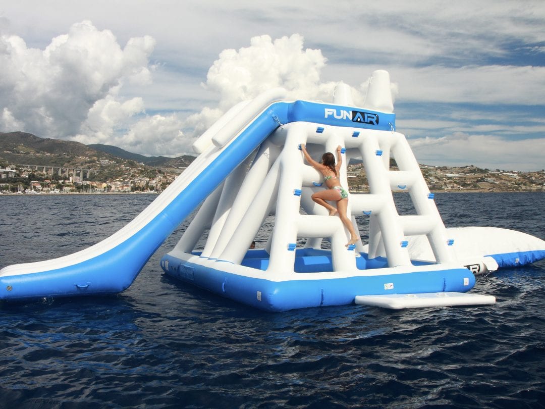 Girl playing on a floating playground and Junior Big Air Blob in the ocean