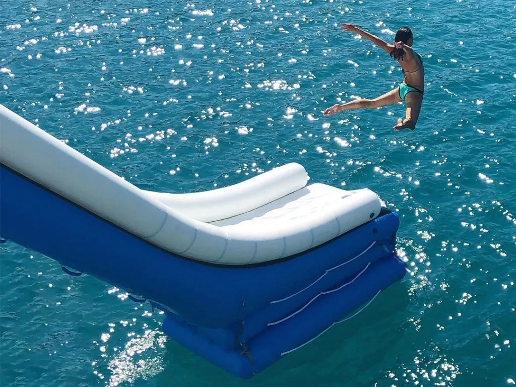 charter-guest-jumping-off-the-end-of-an-inflatable-superyacht-slide