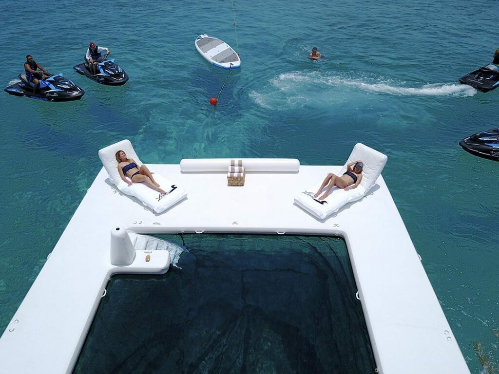 Charter-guests-relaxing-on-a-Beach-Club-Sea-Pool-on-a-superyacht