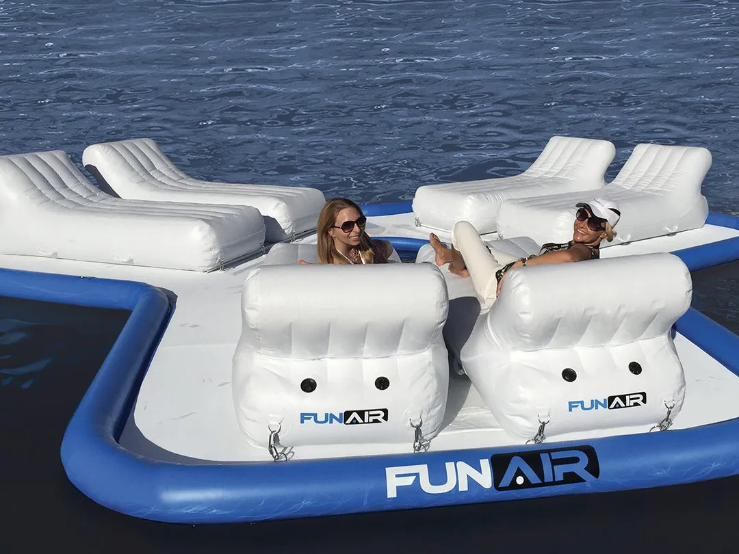 Two women charter guests enjoying the FunAir Floating Island from a superyacht