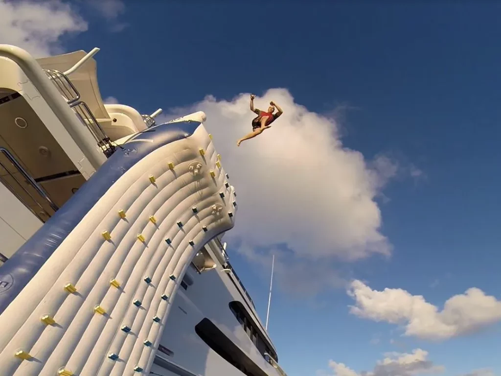 Charter guest jumps from the climbing wall on superyacht Lazy Z
