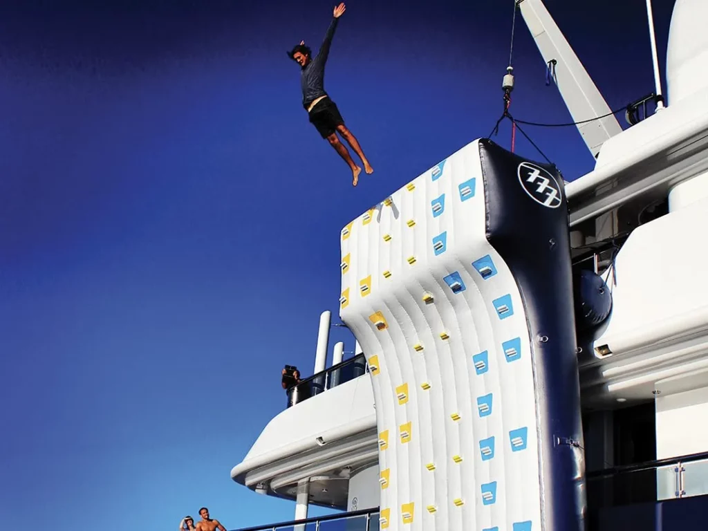 Guest jumping off the superyacht climbing wall on charter yacht MY 777