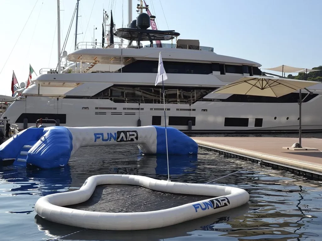 FunAir floating golf green and water joust in front of superyachts on a marina