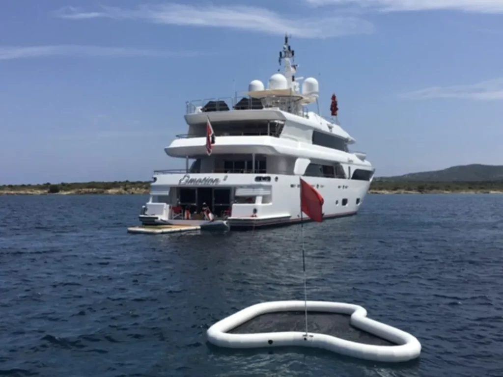 FunAir inflatable floating golf green in front of a superyacht