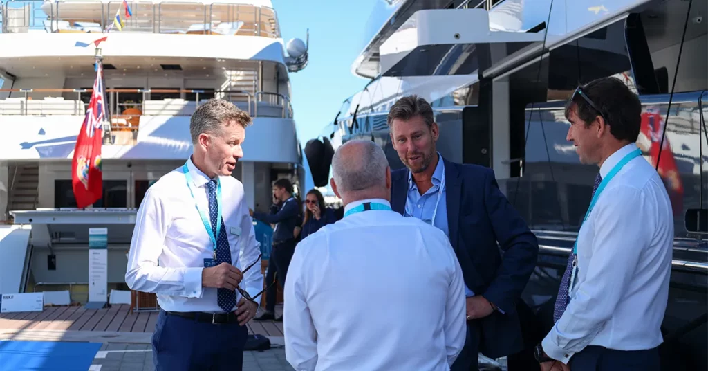 Yacht Recruiters and Brokers talking in front of superyachts at the Monaco Yacht Show