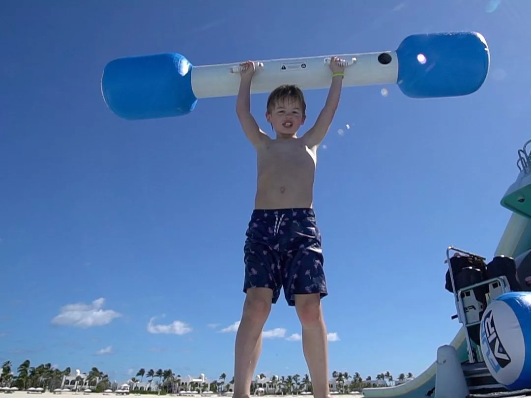Boy on charter superyacht with Water Joust pole