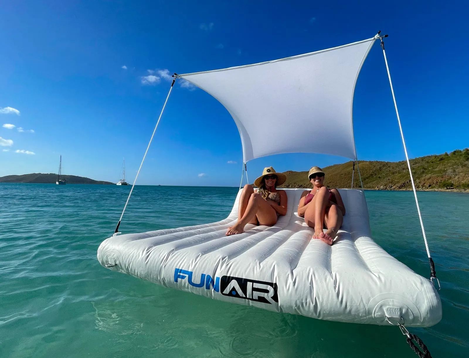 Charter guests from MY Foxy Lady on a Floating Shaded Lounger