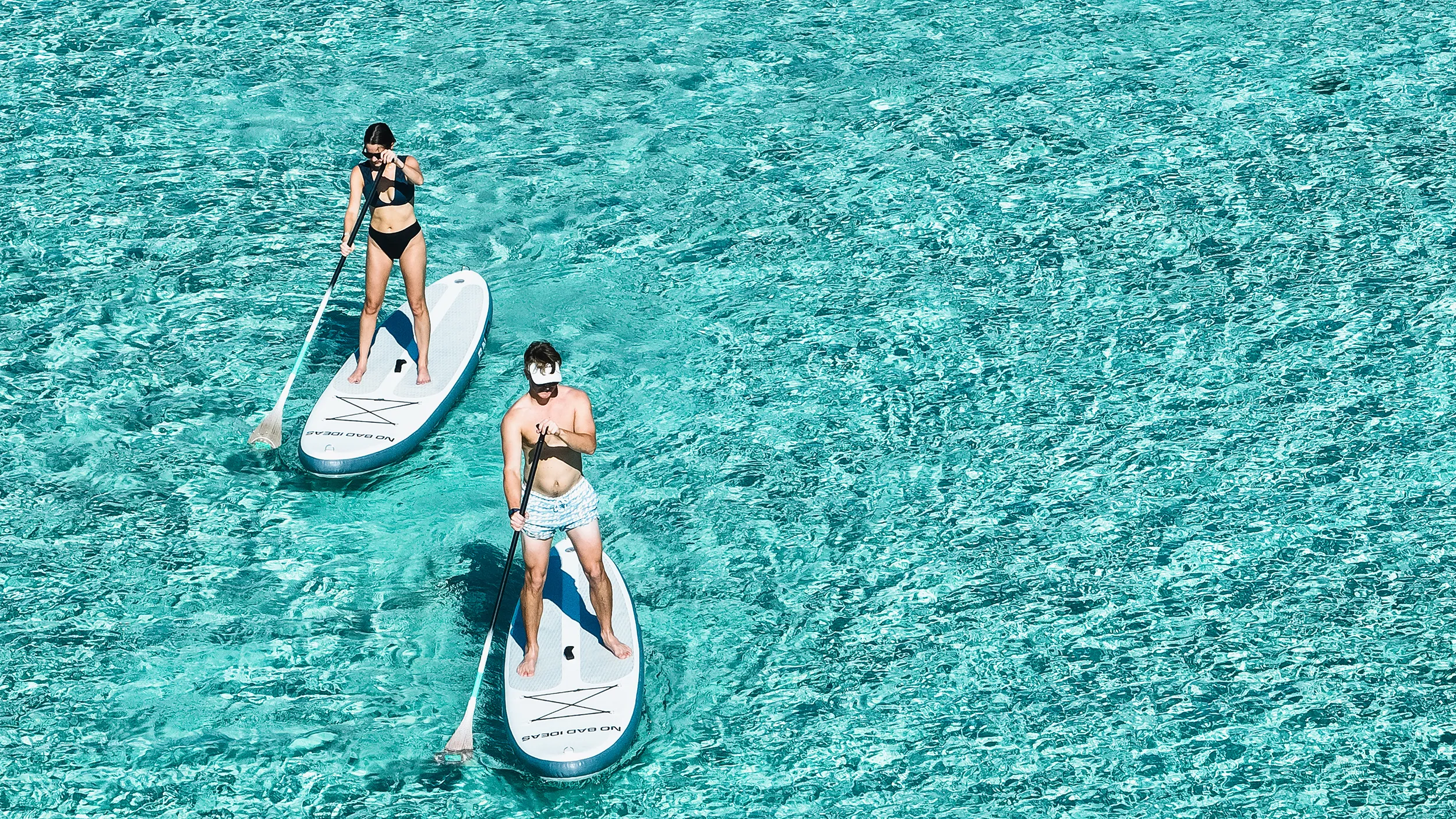 Charter guests using FunAir Stand Up Paddleboards from superyacht No Bad Ideas