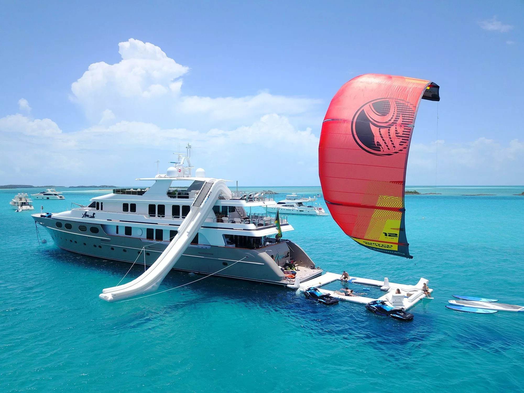 Drone view of Motor Yacht Loon with Yacht Slide Sea Pool and kite surfer