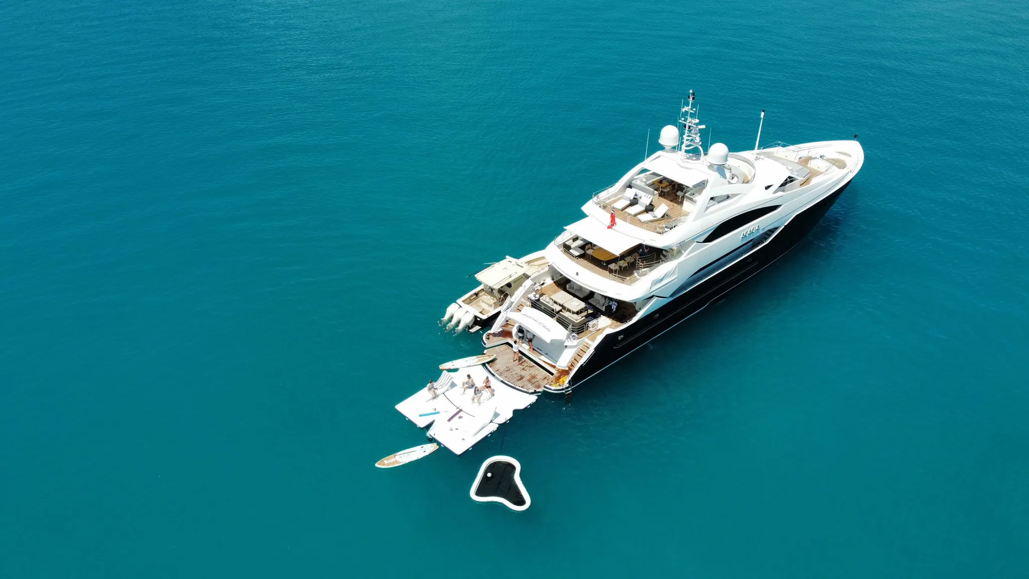 Motor Yacht Acacia Swim Platform Extension Yacht Golf drone shot agains blue ocean