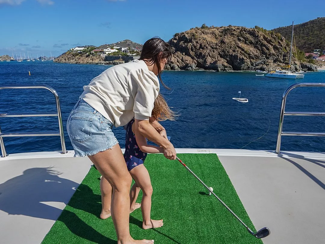 Parent and daughter playing Yacht Golf on a charter superyacht