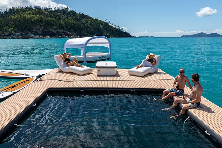 Sea Pool Wave Lounger Shaded Oasis SUP Inflatable table four charter guests relaxing