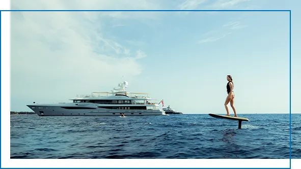 Charter superyacht with a guest riding a Fliteboard