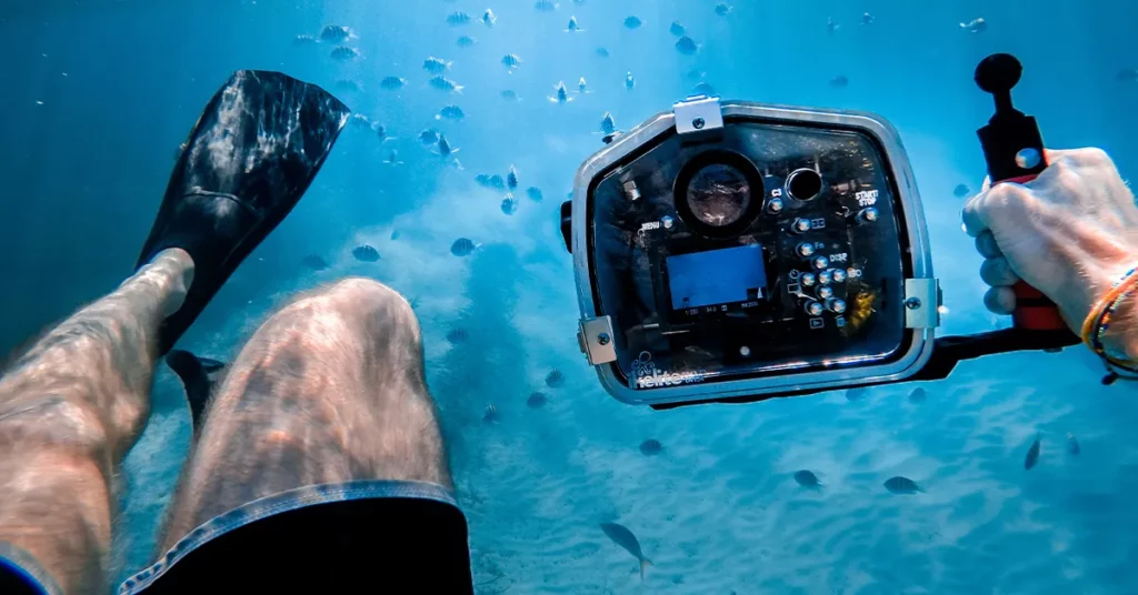 Superyacht crew member using an underwater camera