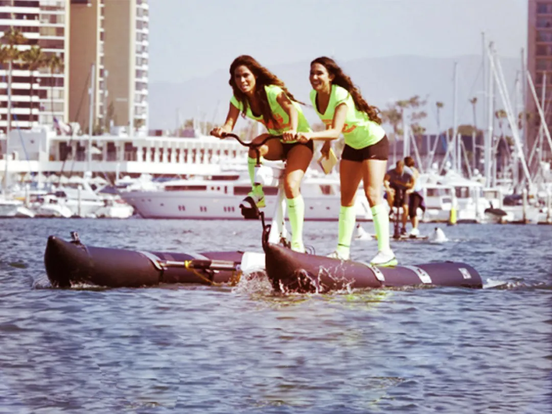 Two women riding a Schiller Bike in a harbour