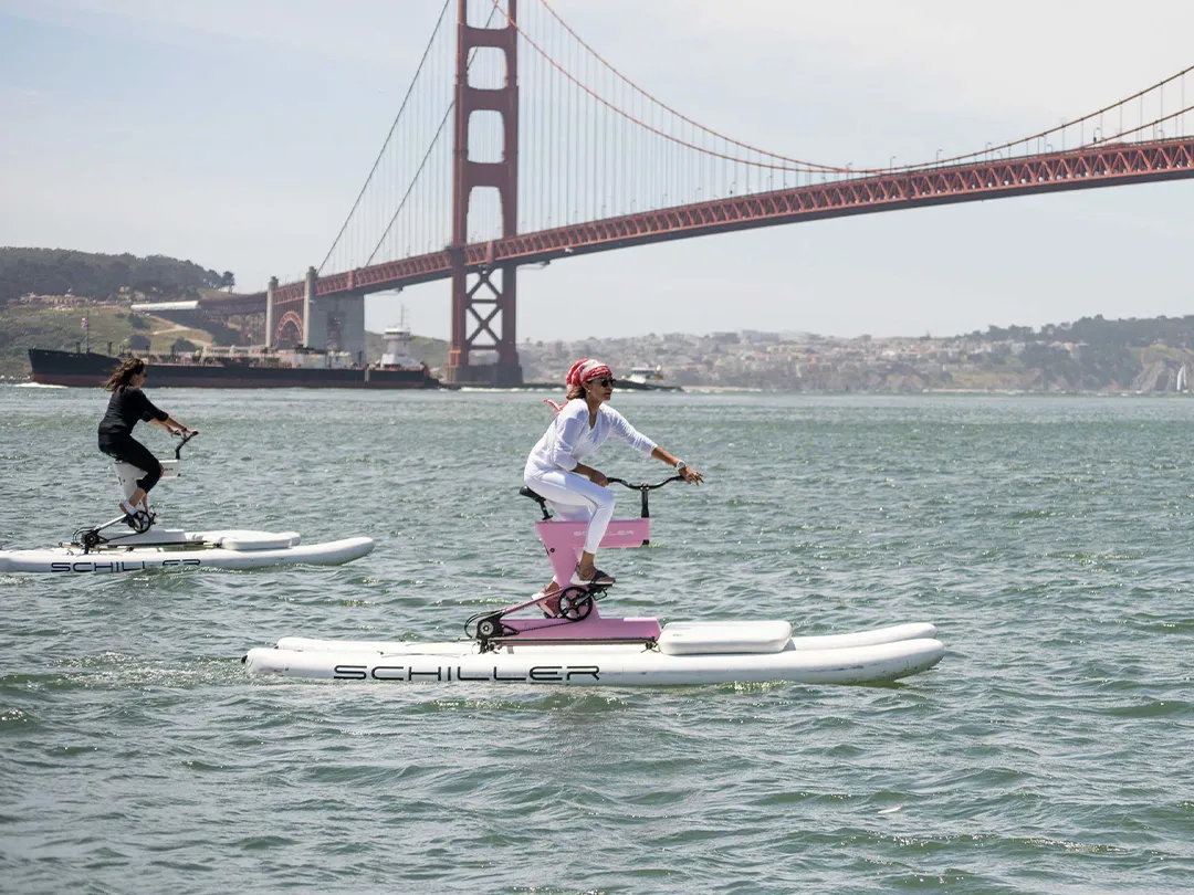 Two women riding Schiller Bikes near the Golden Gate Bridge