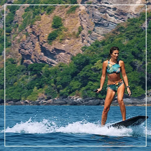 Female charter guest on an SUP with SCUBAJET attached