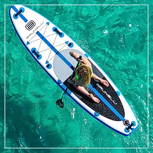 Superyacht charter guest on an SUP