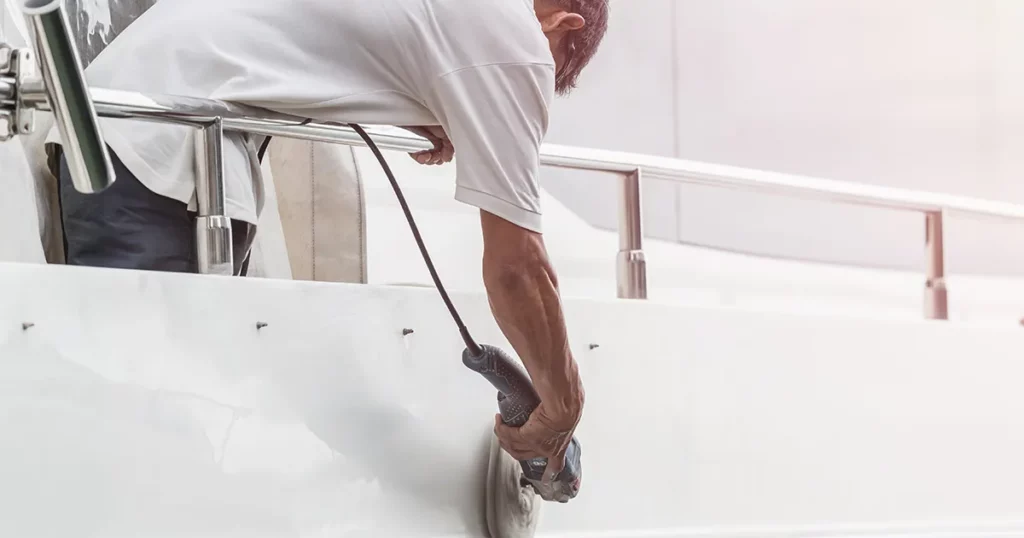 Superyacht crew member doing maintenance on a yacht
