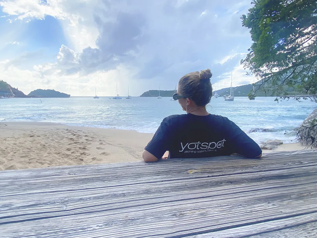 Superyacht crew member relaxing on a beach