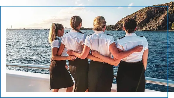 Superyacht stewardesses looking out from a charter yacht