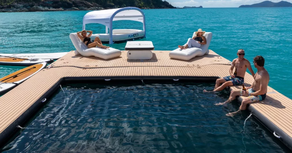 charter guests enjoying the superyacht inflatable seapool loungers table and shaded oasis on MY Impulsive