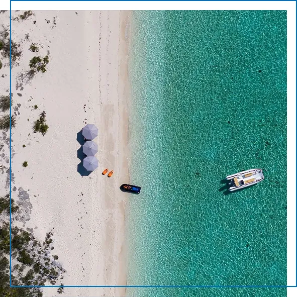 Drone view of the tender from charter yacht MY crossed Sabre anchored at a Caribbean beach