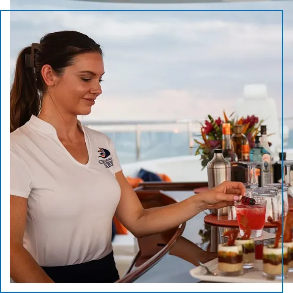 MY Crossed Sabre crew member making cocktails for guests on a luxury superyacht charter