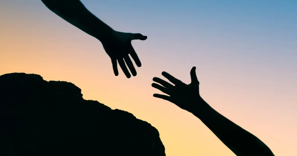 Superyacht crew members reaching out hands for support