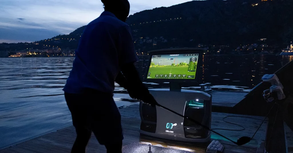 Charter guest playing golf games at night using an Off the Deck SeaDrive CX on board a superyacht