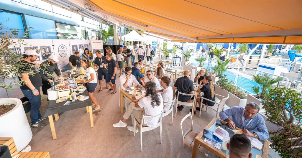 superyacht crew enjoying the outside seating at the C&C Lounge at MYS