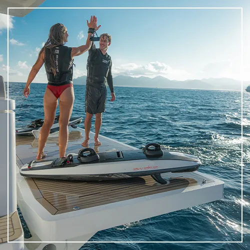 superyacht guest and crew member with an Awake Board on a yacht charter