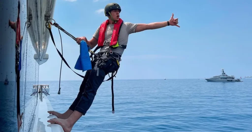 Charter superyacht deckhand working on a luxury yacht